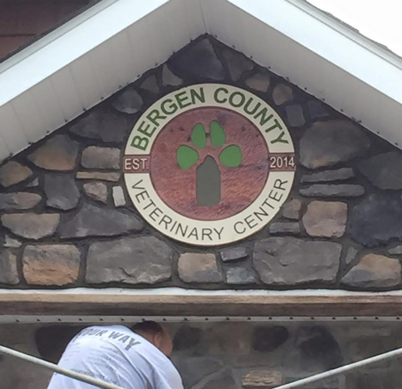Custom stonework with embedded business signage for veterinary center